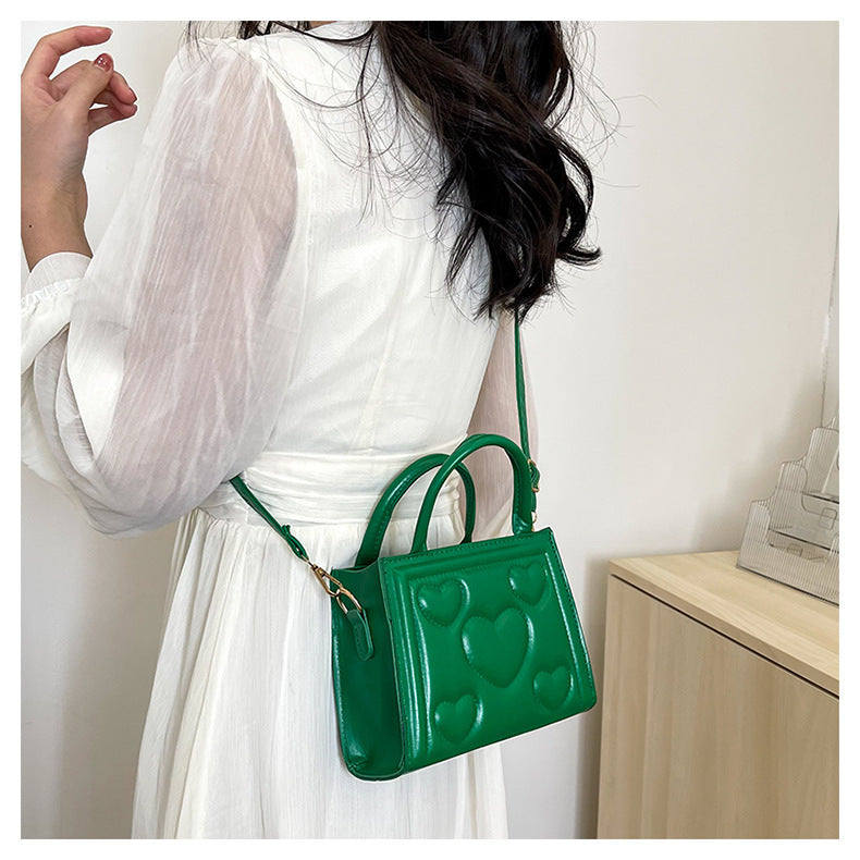 1pc Women’s Stylish Solid Color Handbag with Detachable Strap – Heart Pattern Design, Perfect for Valentine’s Day Gift, Available in Magenta, White, Black, Green, Yellow
